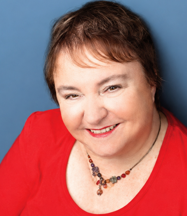 Maggie Richardson smiling in a red top